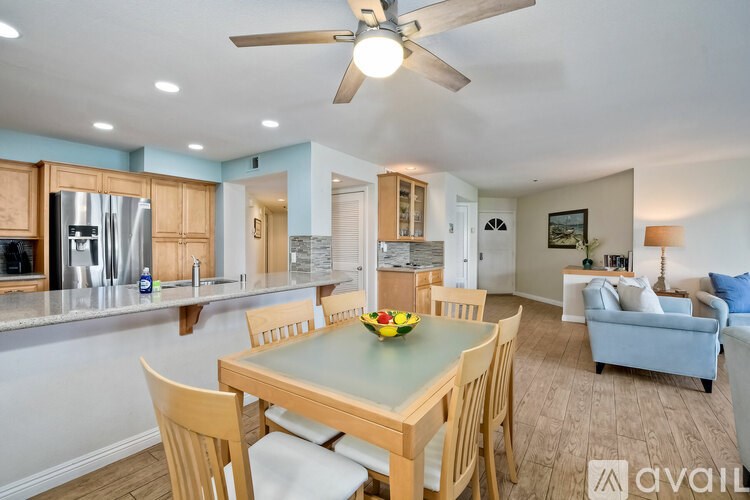 A kitchen with a table and chairs in the middle of the room.