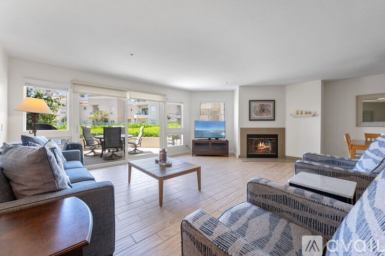 A kitchen with a granite countertop and wooden cabinets.