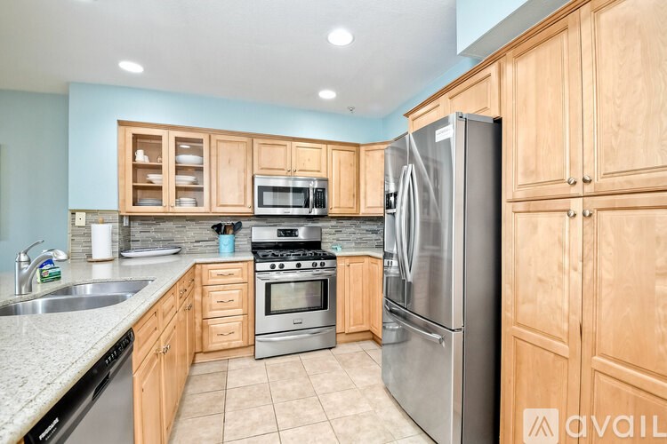 A kitchen with wooden cabinets and stainless steel appliances.