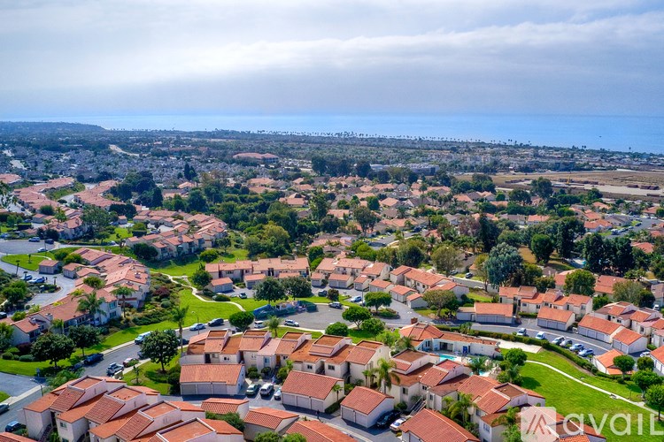 A bird's eye view of a residential area with houses and greenery.