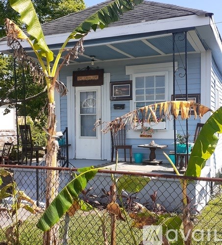 A blue house with a sign that says "Banana" on it.