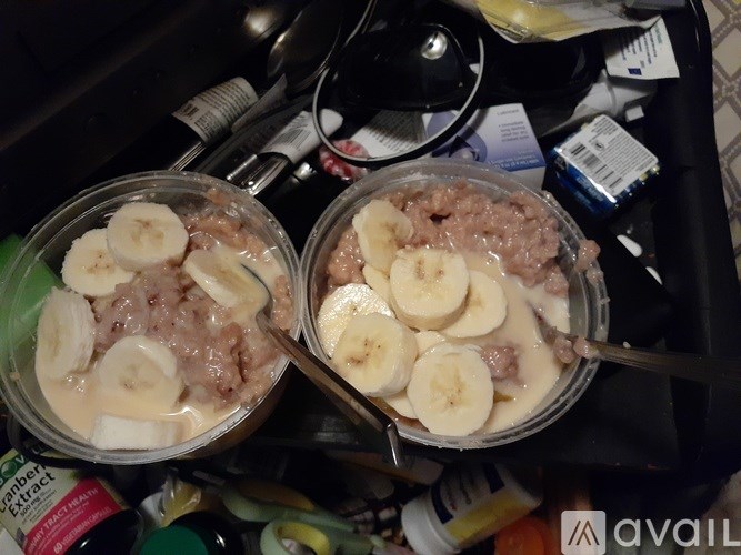 Two bowls of oatmeal with banana slices on top.