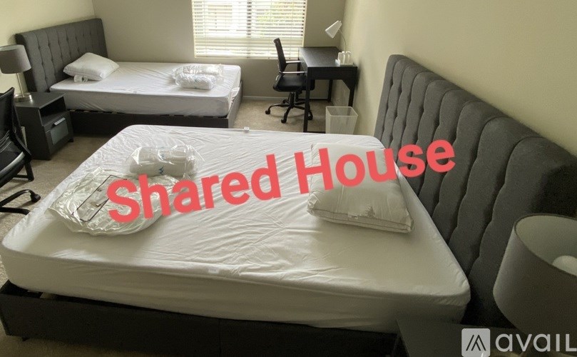 A bedroom with a bed, desk, and chair, labeled "Shared House".