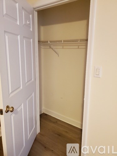 A white door is open to a small closet.