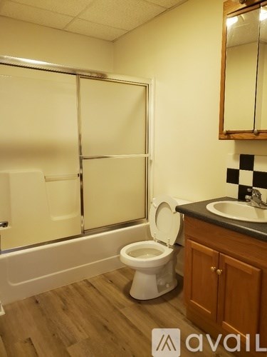 A bathroom with a toilet, sink, and bathtub.