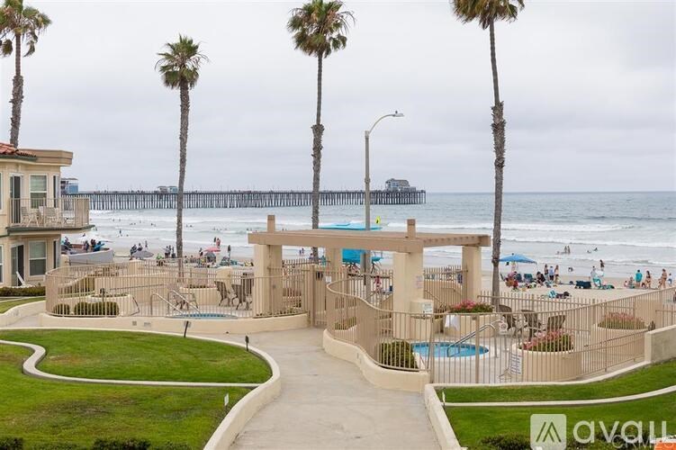 A beachside resort with a pier in the background.