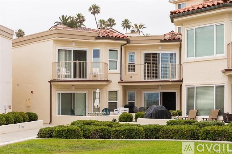 A two-story house with a balcony and a patio.