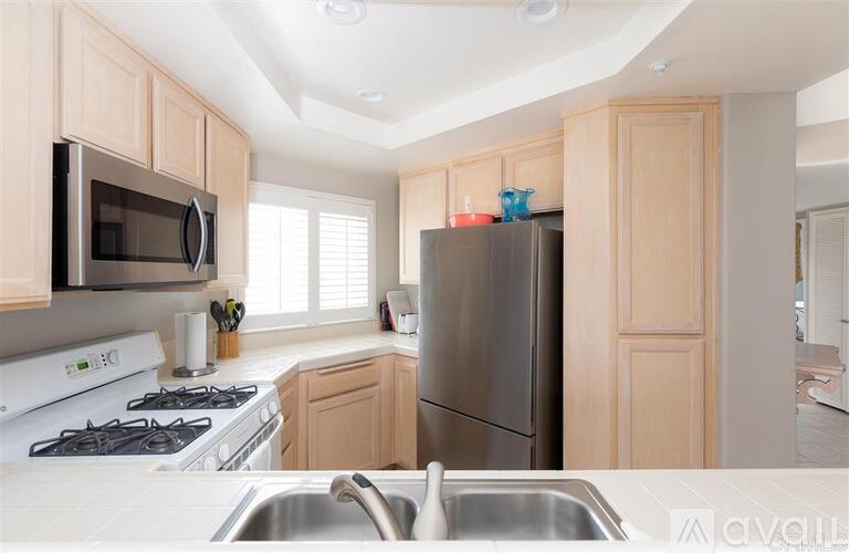 A kitchen with a stove, microwave, and refrigerator.