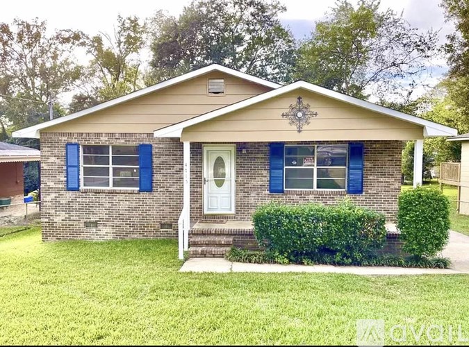 A house with a white door and blue shutters.