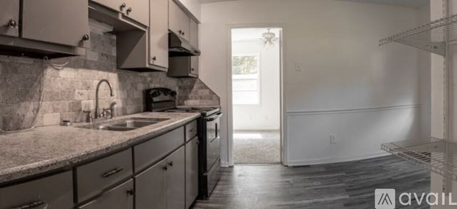 A kitchen with granite countertops and a sink.