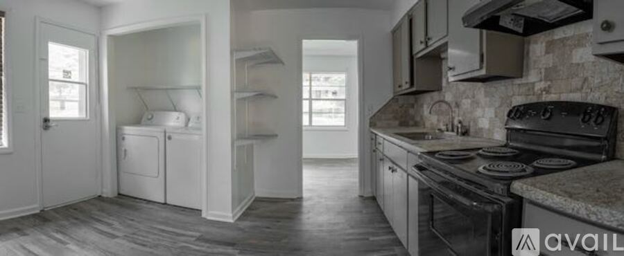 A kitchen with a black stove top oven and a white fridge freezer.