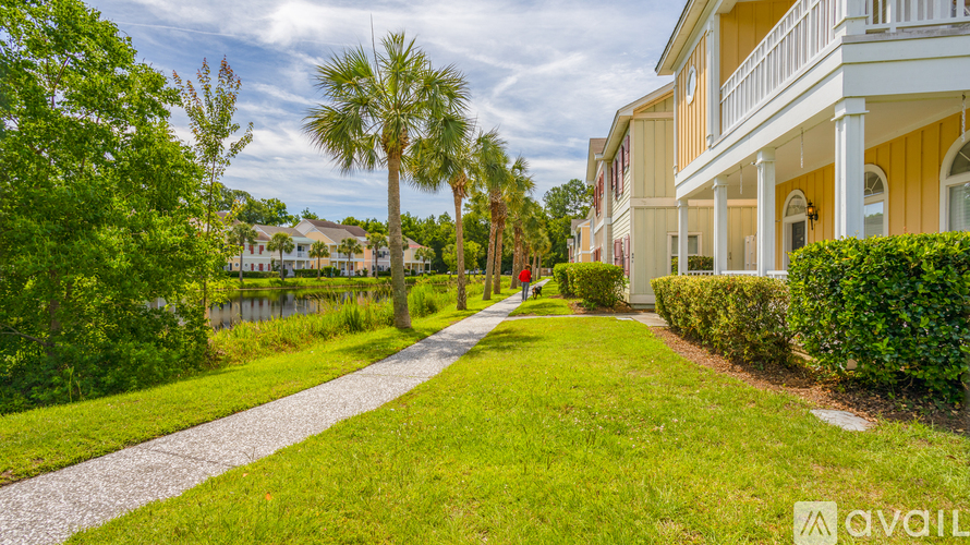 A house with a white fence and a green lawn.