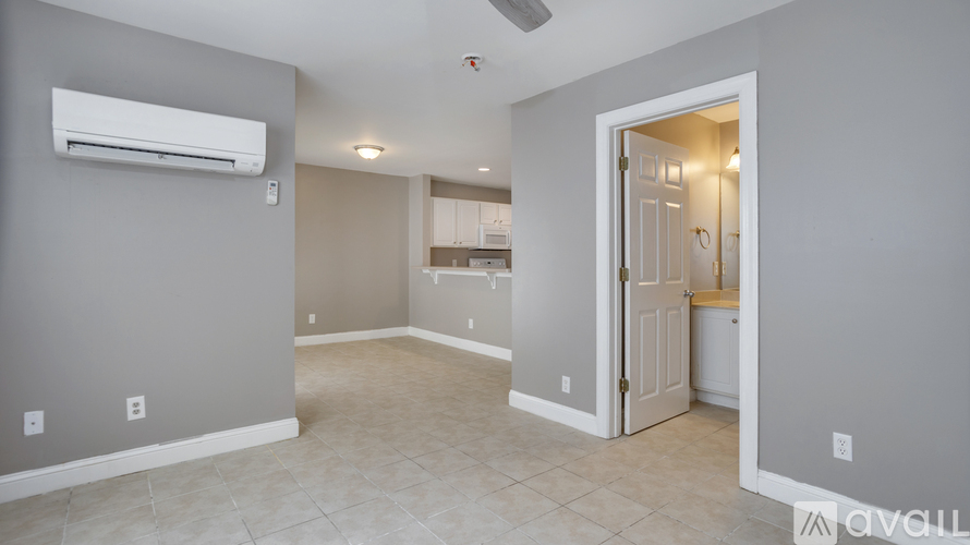 A room with a ceiling fan and an air conditioner unit.