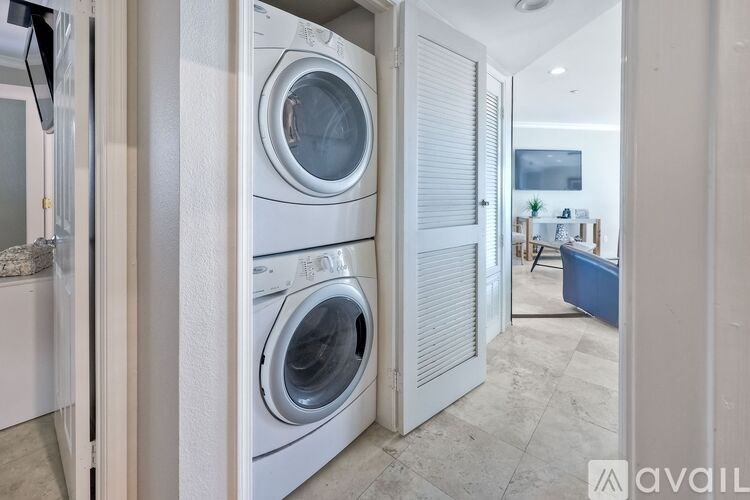 A laundry room with a washer and dryer stacked on top of each other.