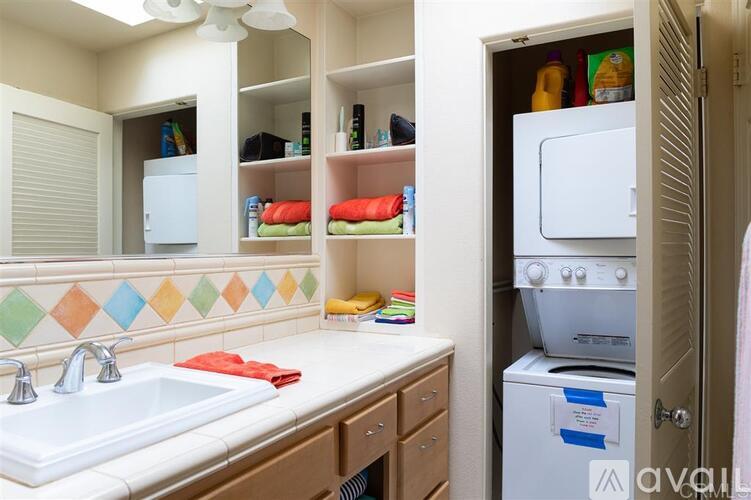 A kitchen with a white sink and a white refrigerator.