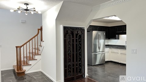 A kitchen with a refrigerator, stove, and oven is available for rent.