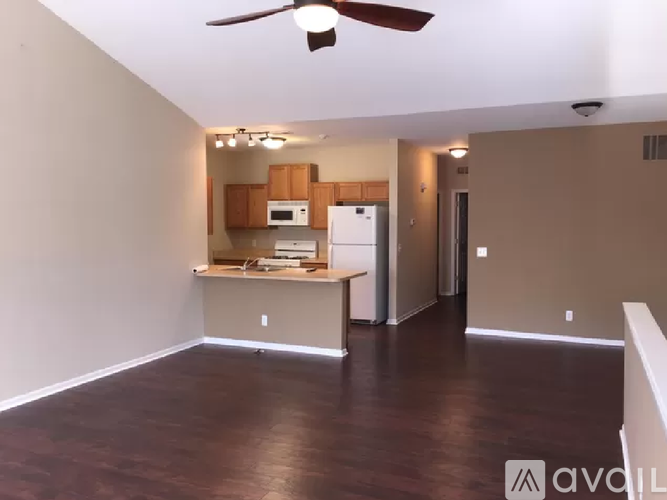 A kitchen area with a refrigerator, microwave, and oven.