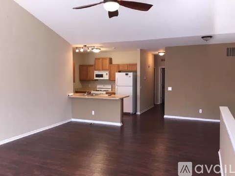 A kitchen area with a refrigerator, microwave, and oven.