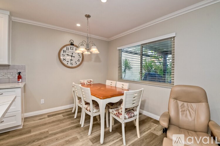 A dining room with a wooden table and chairs.