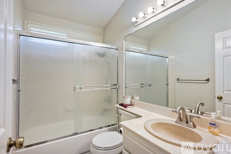 A bathroom with a toilet, sink, and shower.