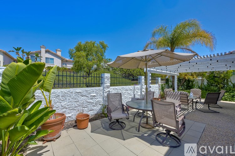 A patio with a table and chairs under a canopy.