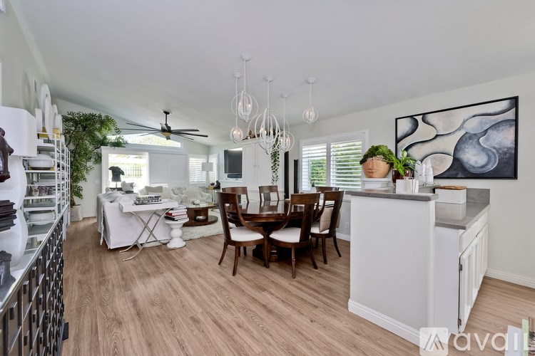 A kitchen with a dining table and chairs.