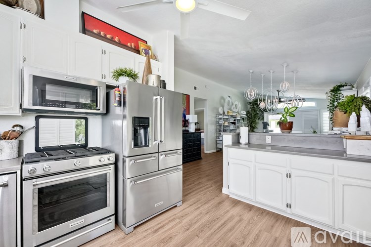 A kitchen with white cabinets and stainless steel appliances.