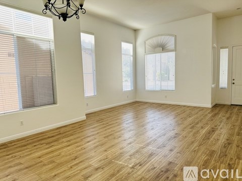 A room with wooden floors and a chandelier.