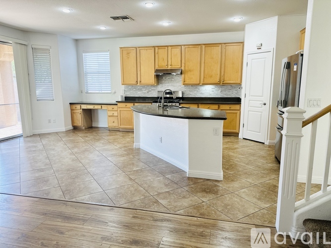 A kitchen with wooden cabinets and a black countertop.