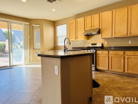 A kitchen with wooden cabinets and a black countertop.