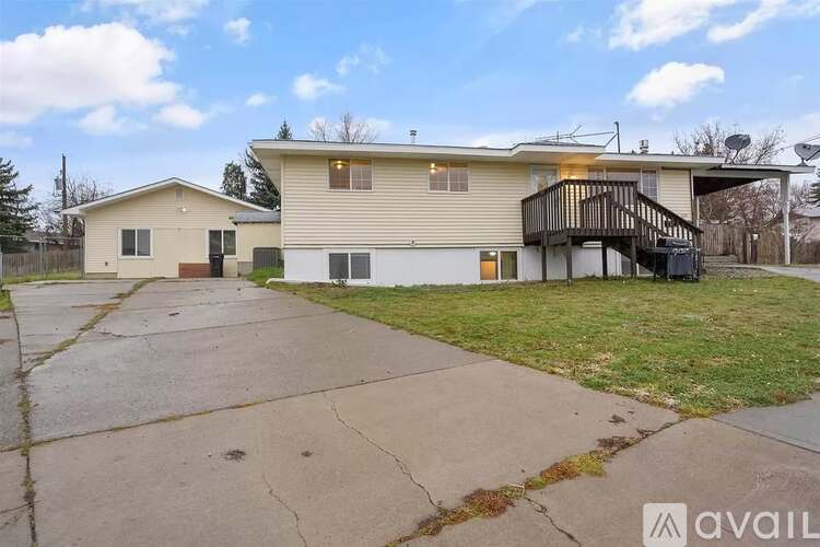A two-story house with a garage and a balcony.