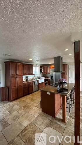 A kitchen with wooden cabinets and a tiled floor.