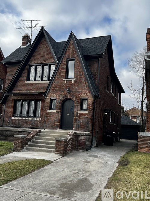 A brick house with a black door and windows.