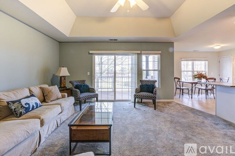 A living room with a couch, chair, and coffee table.