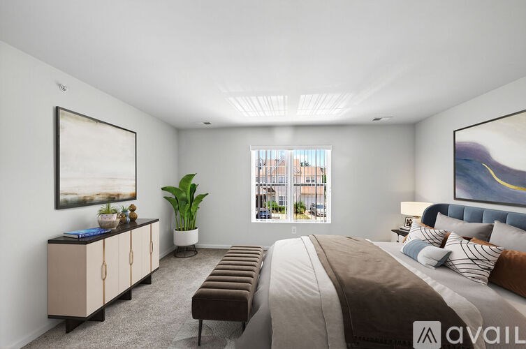 A bedroom with a large bed and a window overlooking a cityscape.