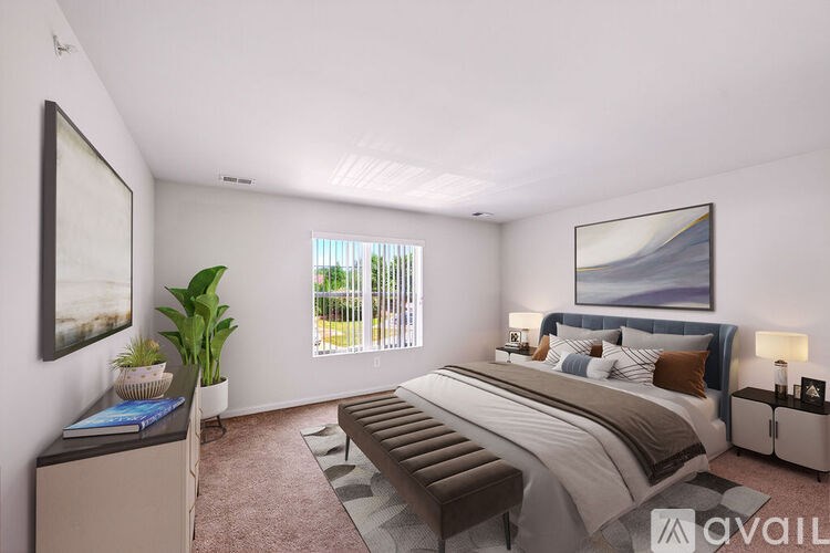 A bedroom with a large bed and a painting on the wall.