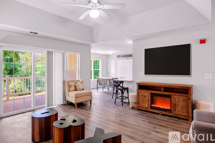 A living room with a fireplace and a flat screen TV.
