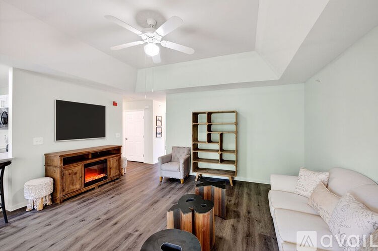 A living room with a white couch and a wooden floor.