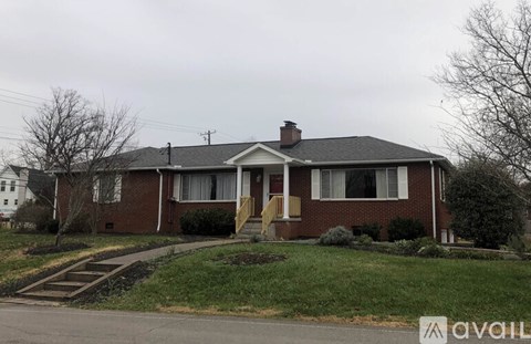 A house with a front yard and a driveway.