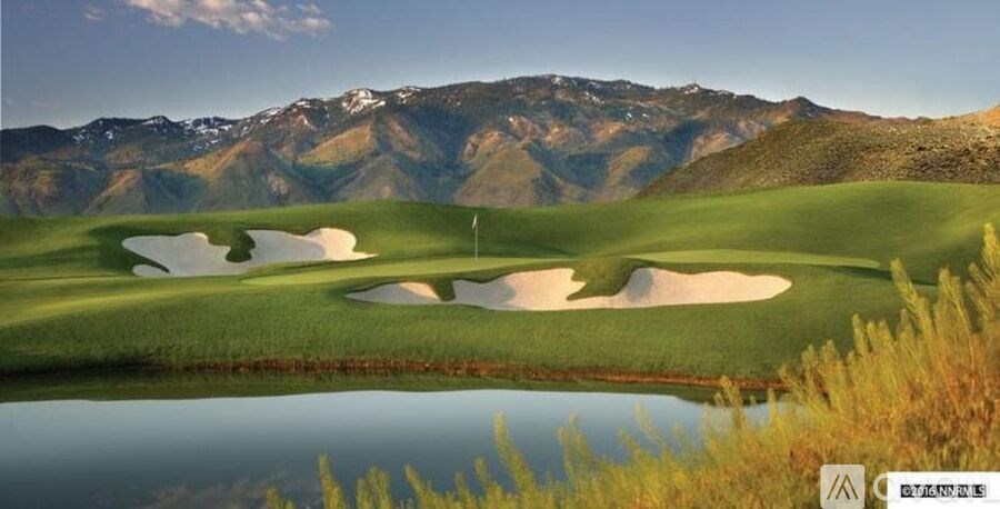 A golf course with a mountain in the background.