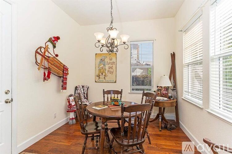 A dining room with a wooden table and chairs.