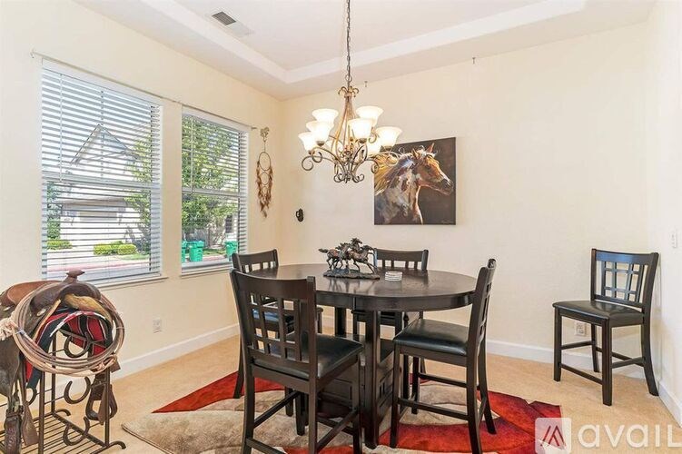 A dining room with a table set for six.