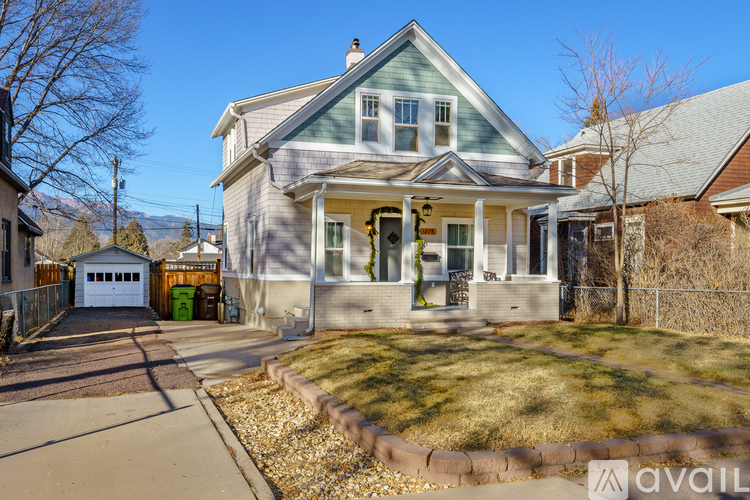 A house with a front yard and a driveway.