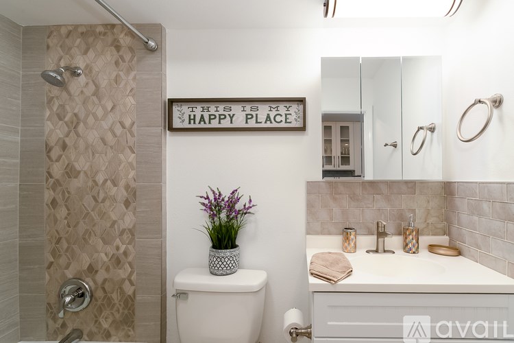 A bathroom with a toilet, sink, and a sign that says "This is my happy place".