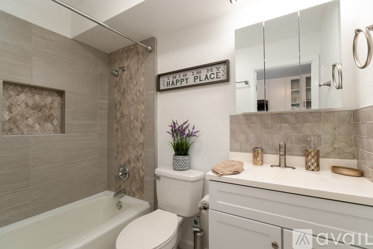 A bathroom with a toilet, sink, and bathtub.