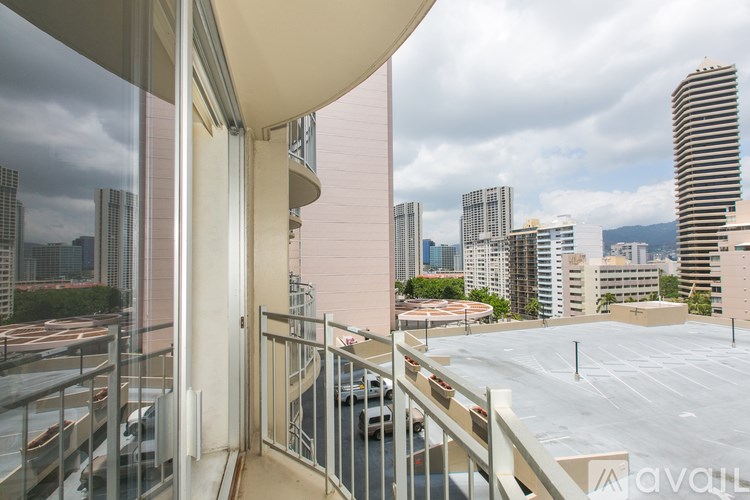 A balcony with a view of a city skyline.