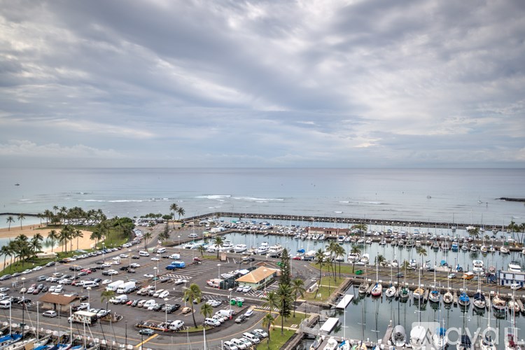 A marina with boats and cars.