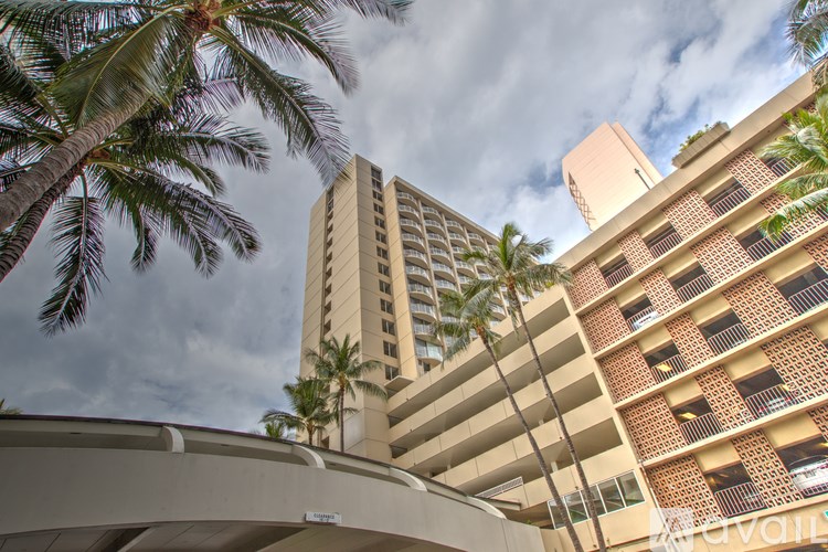 A tall building with a balcony in front of it.