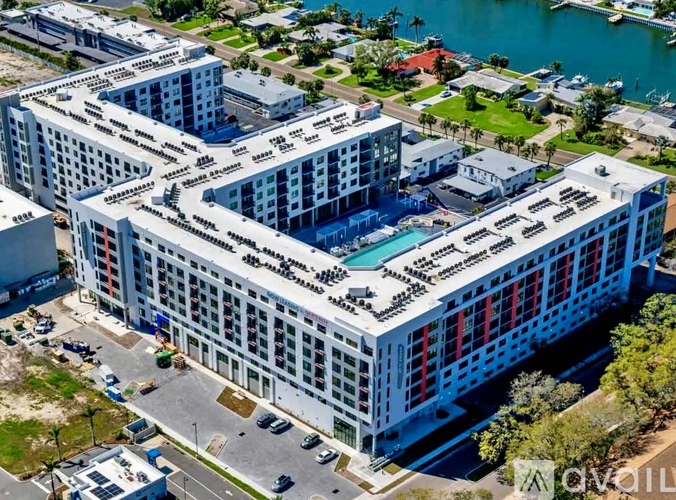 A large white building with a pool in the middle of it.