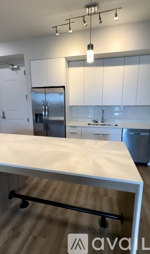 A kitchen with white cabinets and a wooden island.